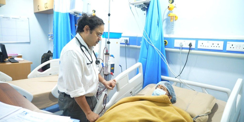 Doctor attending a patient in a hospital bed