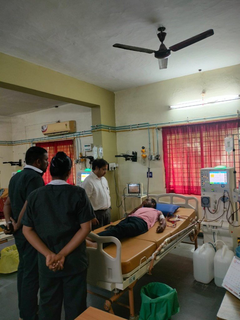 Patient connected to dialysis machine under doctor and staff observation